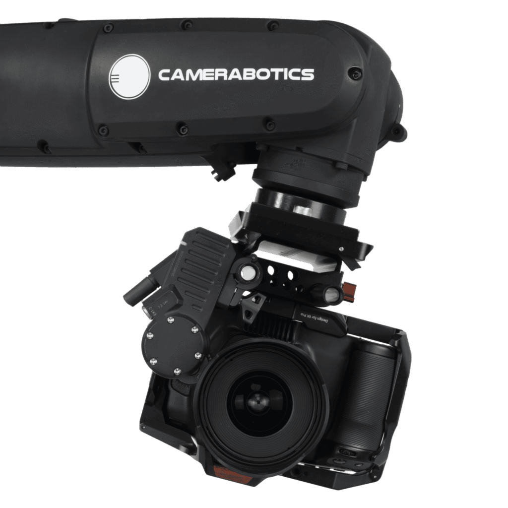 - RobotsInc.com Close-up of a Camerabotics motorized camera gimbal with the lens barrel visible beneath the housing, branding on the side.