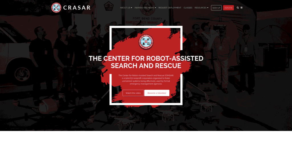 - RobotsInc.com Hero banner for The Center for Robot-Assisted Search and Rescue with logo, red brush stroke, and two CTAs: Watch the video and Become a Volunteer.