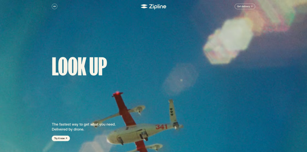 - RobotsInc.com Blue sky hero with Zipline logo, large bold 'LOOK UP' text, and a delivery drone in the lower area.