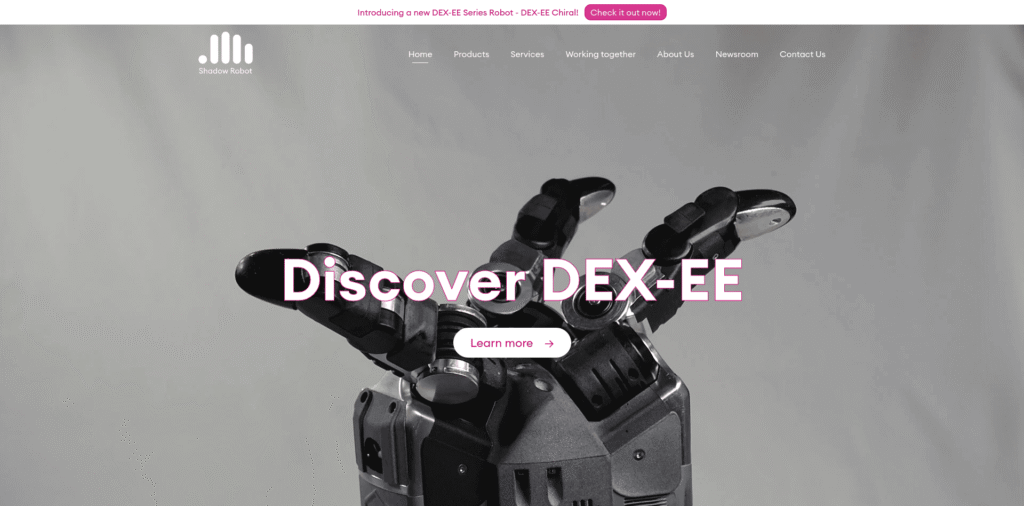 - RobotsInc.com Robotic hand reaching forward with a bold Discover DEX-EE headline and a Learn more button in a gray hero image