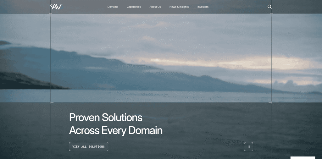 - RobotsInc.com Hero banner with dark translucent header, logo on left and navigation across top, over a blue ocean landscape; large white headline reads 'Proven Solutions Across Every Domain' with a 'View All Solutions' button below.
