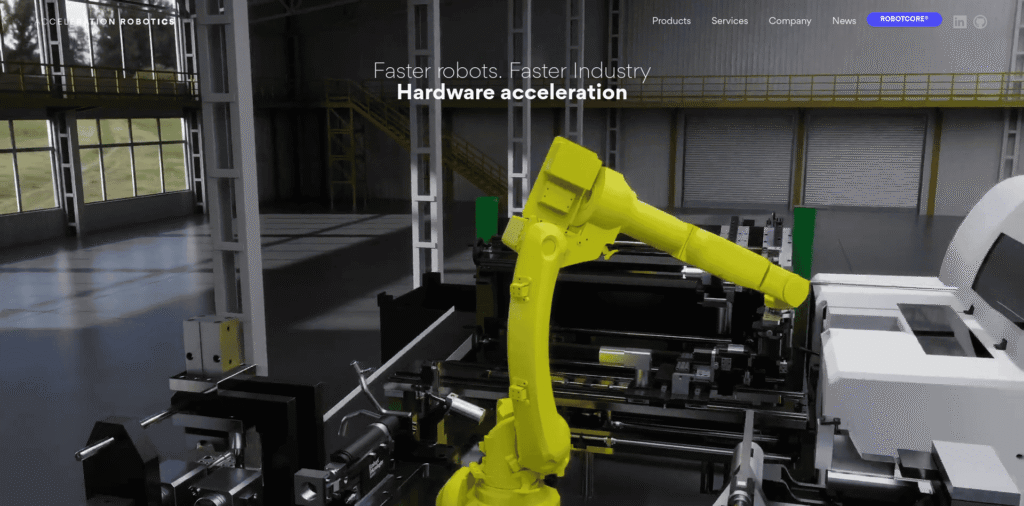 - RobotsInc.com Yellow industrial robot arm operating in a factory workcell among metal machinery and loading bays.