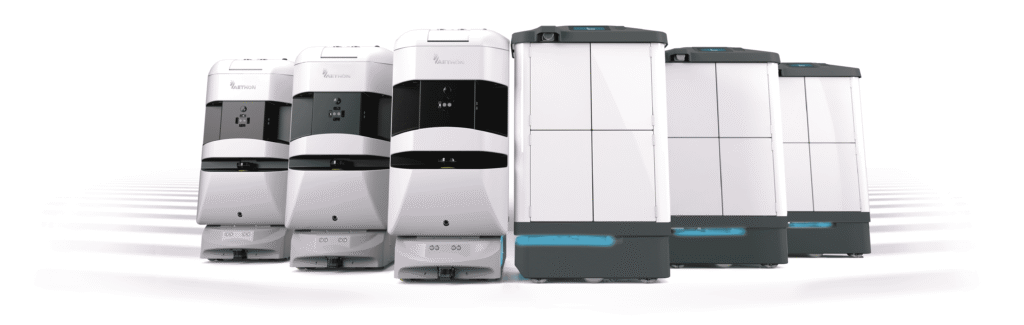 - RobotsInc.com Row of six automated industrial printers in white and gray, lined up side by side.