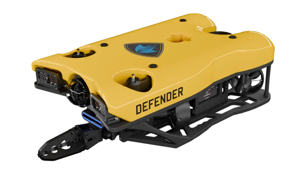 - RobotsInc.com Autonomous yellow snow-plow robot named Defender with tracked chassis and blue logo, designed for winter clearing.