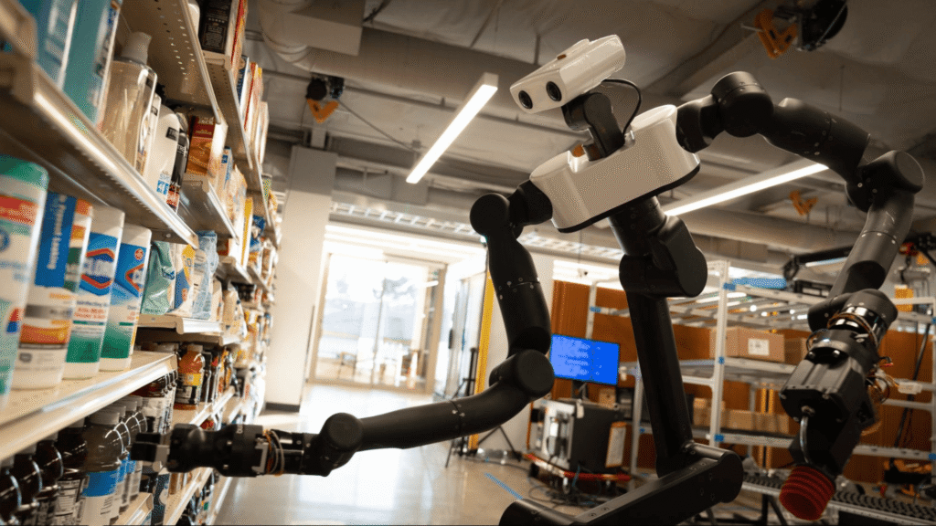 - RobotsInc.com Industrial robotic arm in a supermarket aisle reaching toward shelves stocked with bottles and boxes.
