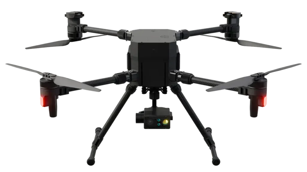 - RobotsInc.com Six-armed hexacopter drone with a central body, landing gear, and a front-facing camera hub beneath the fuselage.
