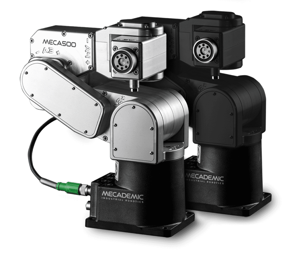 - RobotsInc.com Mecademic Meca500 compact industrial robotic arm with silver joint blocks and black bases, shown from the side with a green connector cable