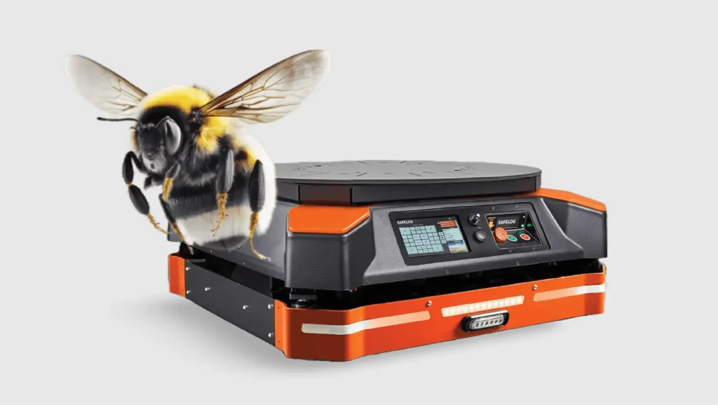 - RobotsInc.com Close-up of a bumblebee perched on an orange and gray industrial device with a digital control panel on display but no readable text on it.