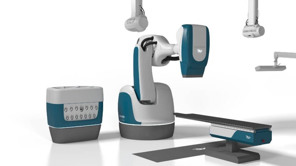 - RobotsInc.com Robotic surgical system with a central robotic arm, console unit, and an adjustable patient table.