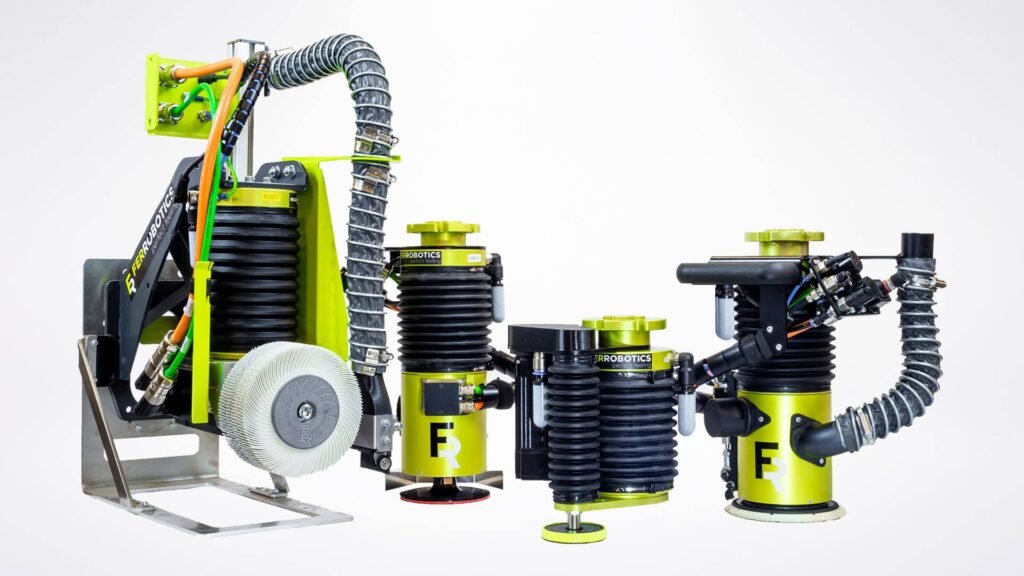 - RobotsInc.com Modular industrial robot components with bright yellow-green frames, black ribbed cylinders, and coiled hoses displayed on a metal stand against a white background.